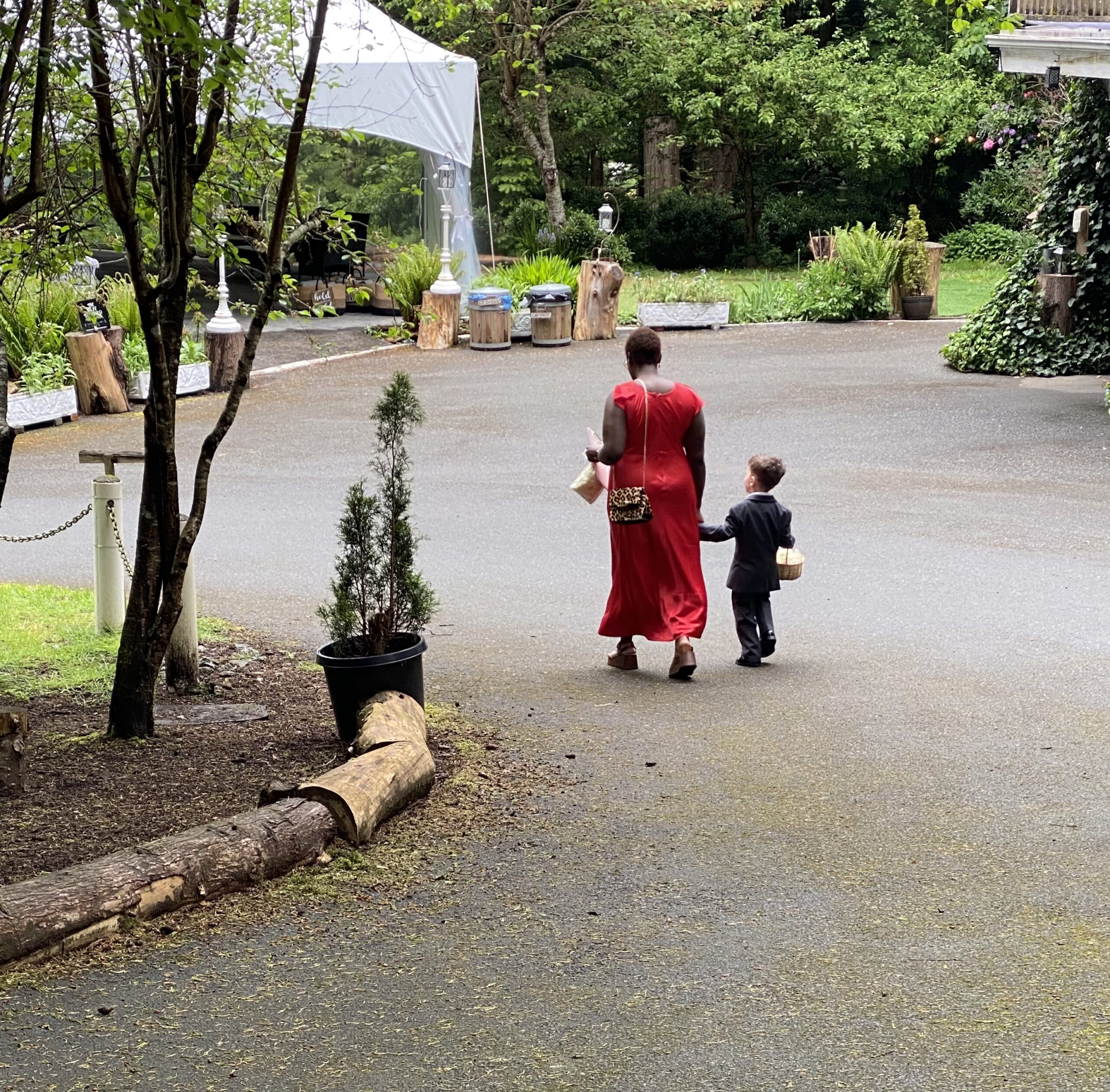 Linda from Fêtes by Linda walking with the ring bearer at a Victoria BC wedding, highlighting a kid-free wedding with special exceptions.