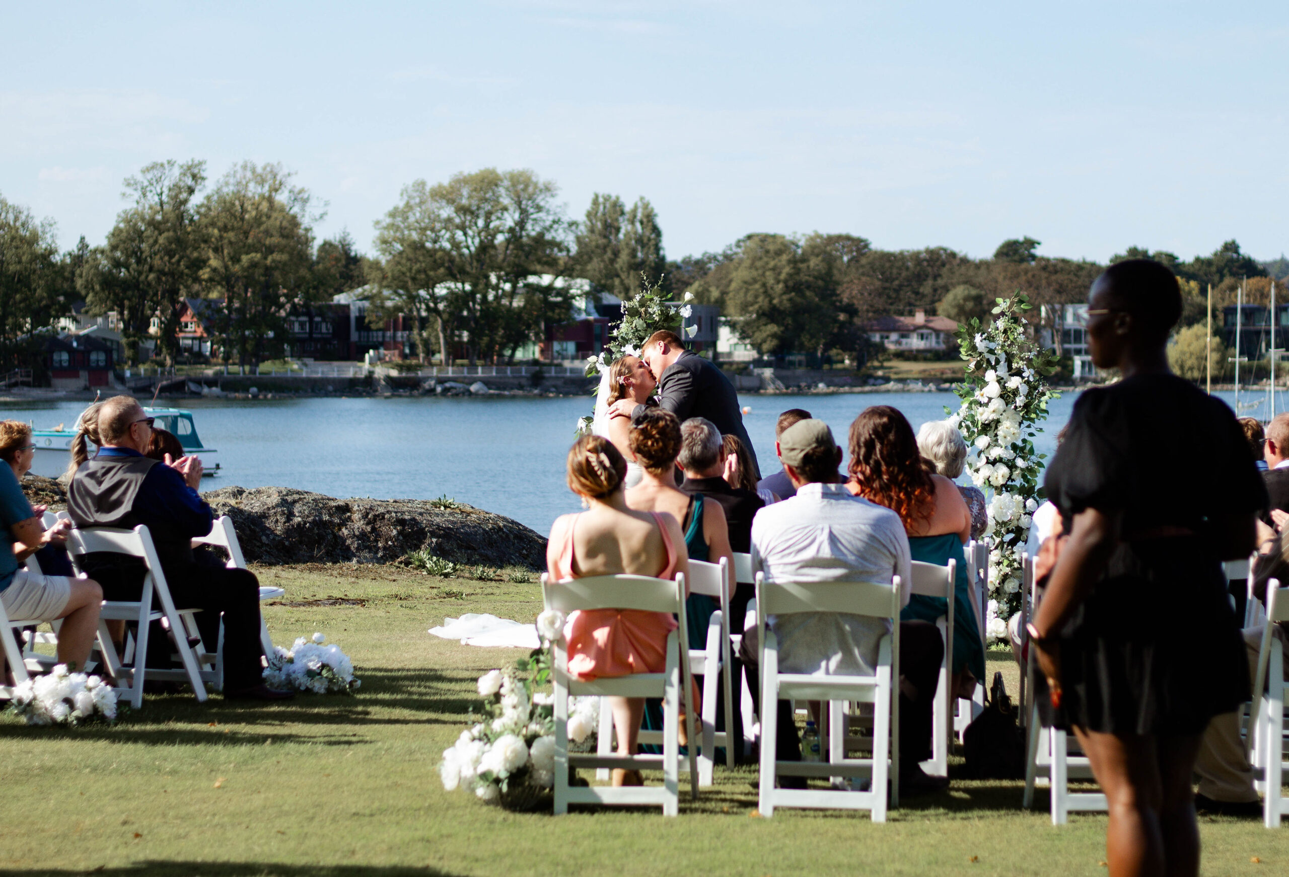 Wedding couple sharing a quiet moment together while their wedding planner manages the day behind the scenes